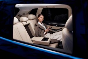 woman sits in the back seat of a limousine