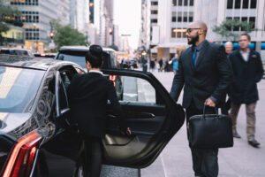 Businesswoman is sitting down in a limousine